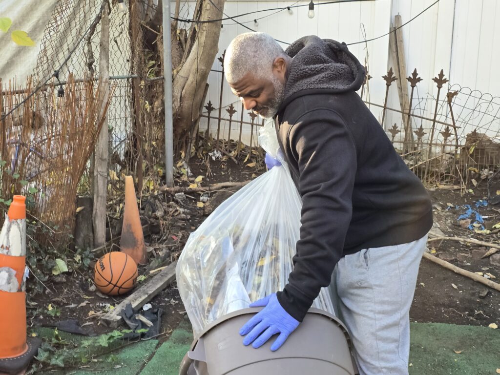 Clean Care Tech bagging leaves during a leaf removal cleanup in Brooklyn, New York